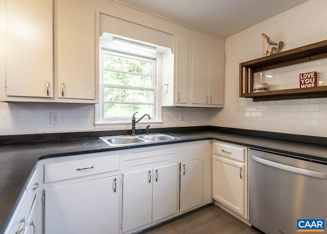 kitchen with dishwasher, backsplash, white cabinets, and sink