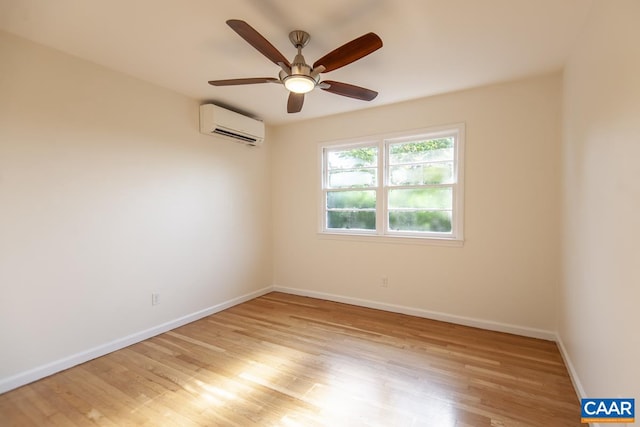 spare room featuring light hardwood / wood-style floors, ceiling fan, and a wall mounted AC