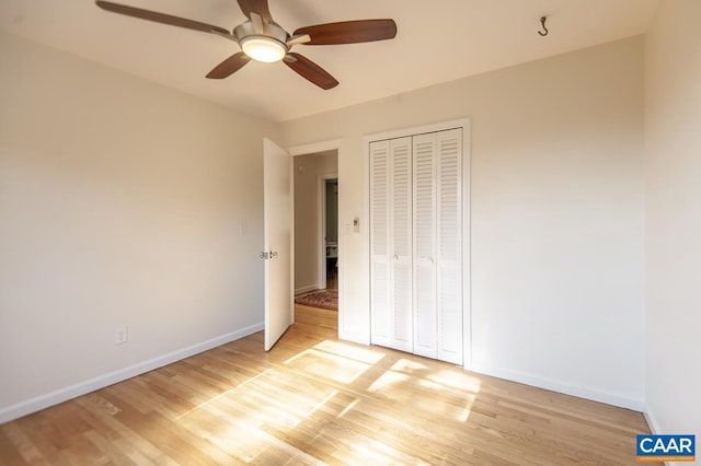 unfurnished bedroom with a closet, light wood-type flooring, and ceiling fan