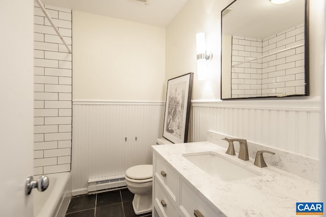 full bathroom featuring tiled shower / bath, vanity, toilet, a baseboard radiator, and tile patterned flooring