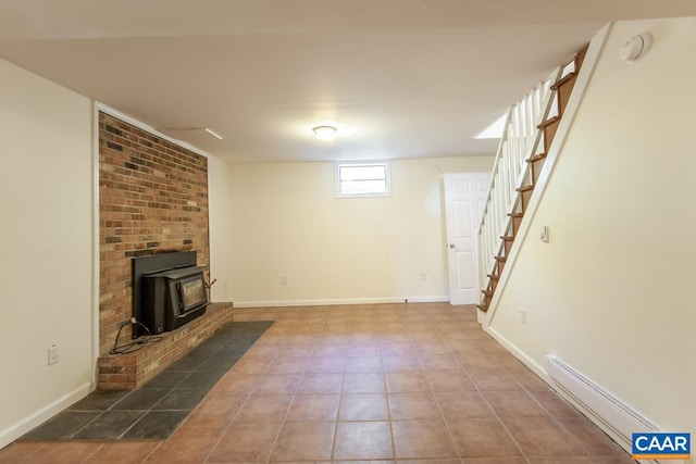 unfurnished living room with a wood stove, tile patterned flooring, and a baseboard heating unit