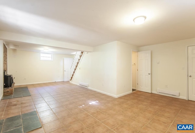 basement featuring a baseboard radiator and light tile patterned flooring