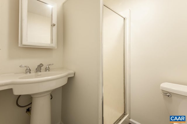 bathroom with walk in shower and toilet