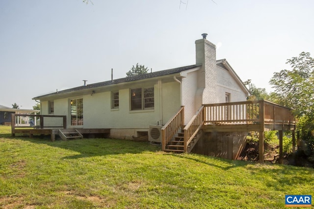 rear view of house featuring a yard, a wooden deck, and ac unit