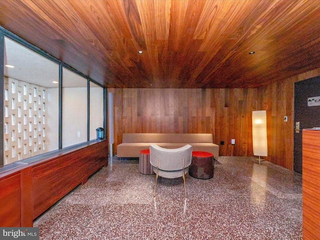 interior space featuring wood ceiling, wooden walls, and speckled floor