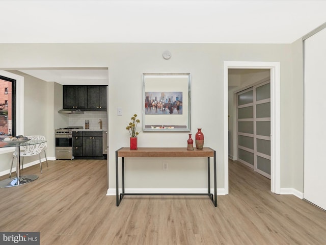 interior space with light wood-style flooring and baseboards