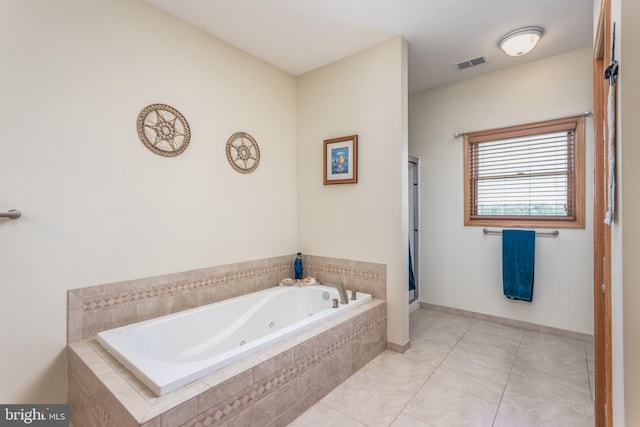 bathroom featuring tiled tub and tile patterned floors