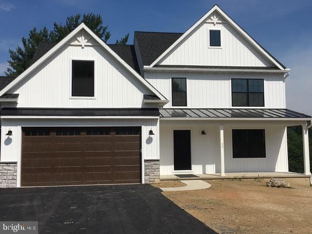 modern inspired farmhouse featuring a garage and a porch