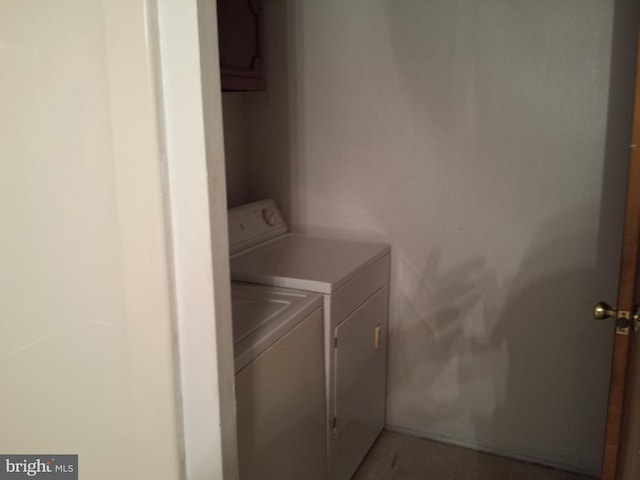 clothes washing area with tile patterned flooring and washing machine and dryer