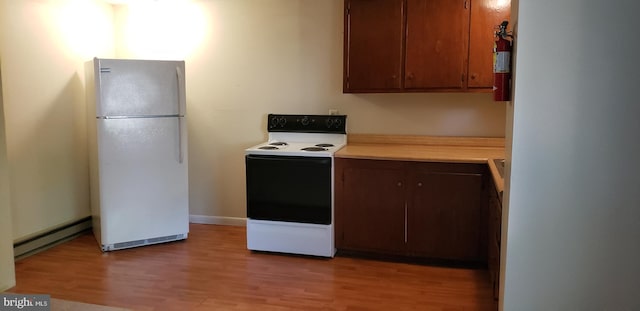 kitchen featuring white appliances, light hardwood / wood-style floors, and baseboard heating