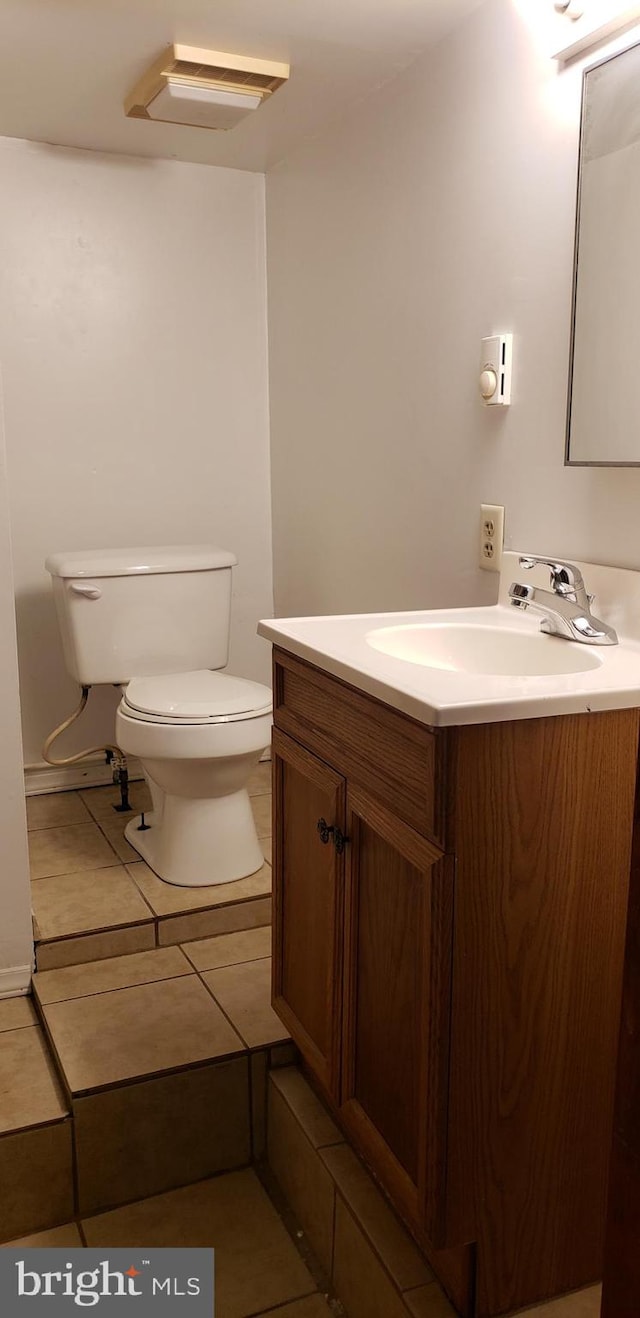 bathroom with vanity, tile patterned flooring, and toilet