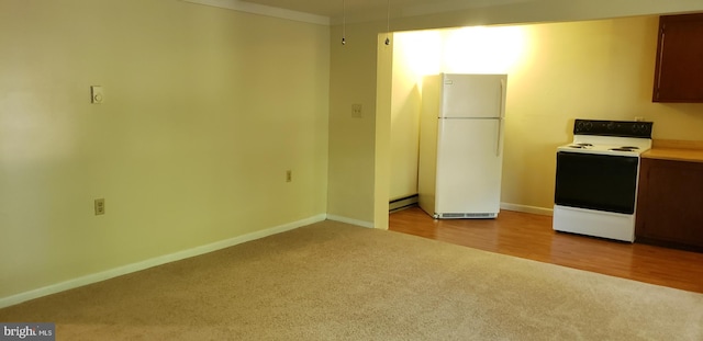 kitchen with white appliances, a baseboard heating unit, and light hardwood / wood-style flooring