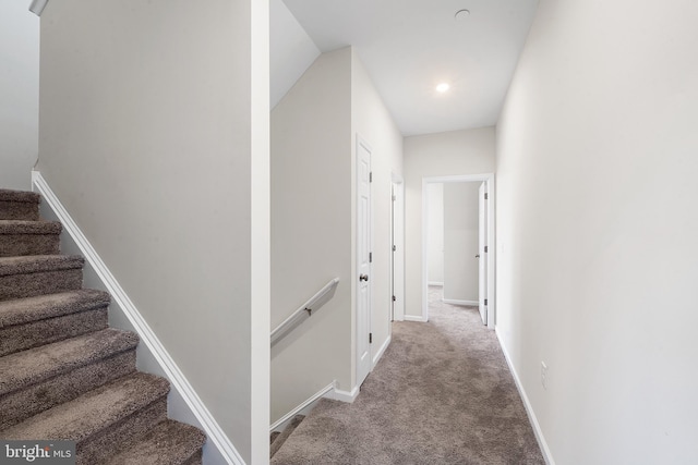 interior space featuring lofted ceiling and carpet flooring