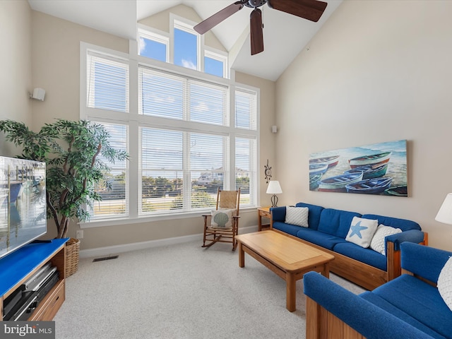 carpeted living room featuring high vaulted ceiling, plenty of natural light, and ceiling fan