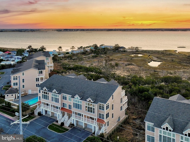 aerial view at dusk with a water view