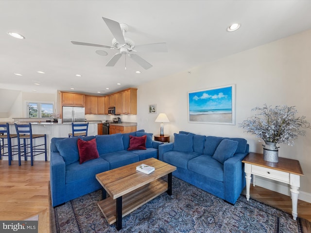 living room featuring hardwood / wood-style flooring and ceiling fan