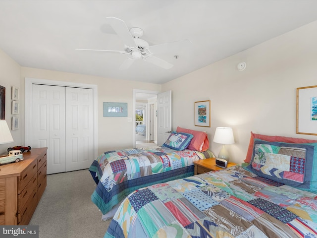 bedroom with a closet, light colored carpet, and ceiling fan