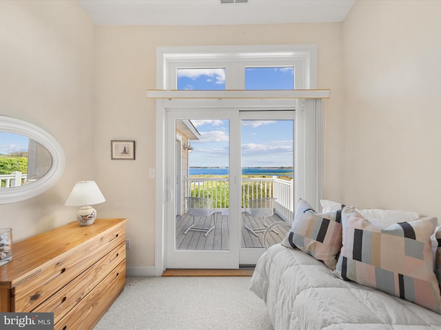 bedroom featuring access to outside and light colored carpet