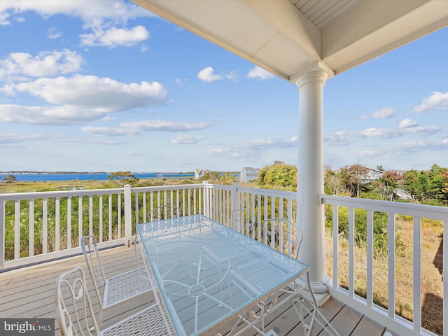 wooden terrace featuring a water view