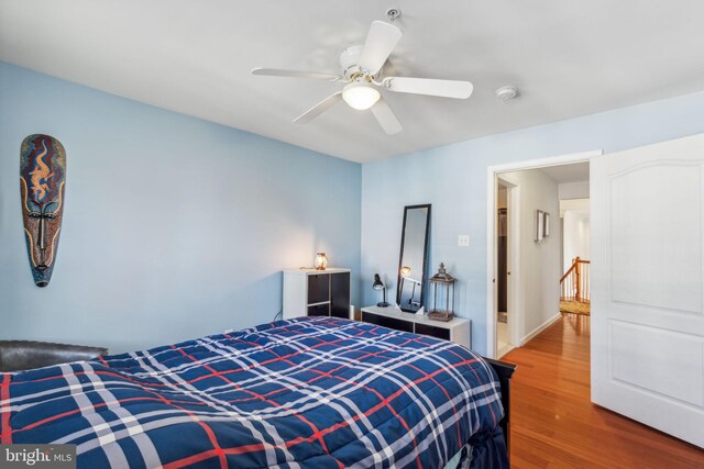 bedroom with hardwood / wood-style floors and ceiling fan