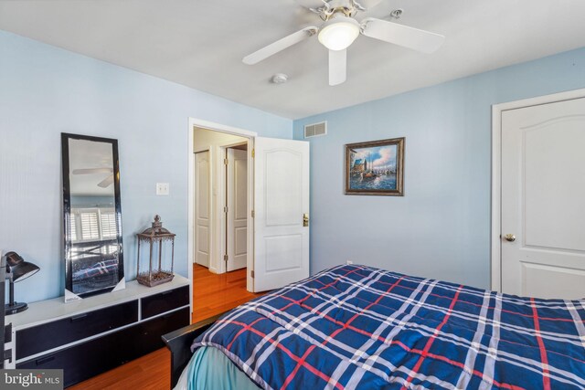 bedroom with wood-type flooring and ceiling fan