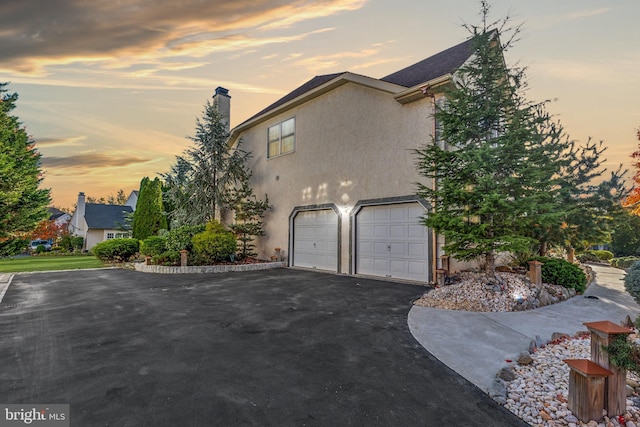 property exterior at dusk with a garage