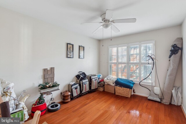 interior space with wood-type flooring and ceiling fan