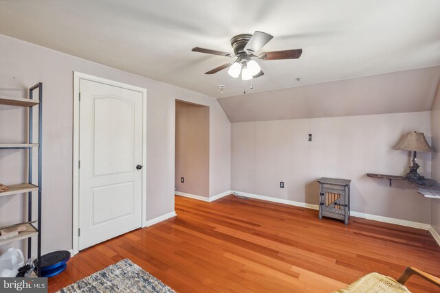 bonus room featuring light hardwood / wood-style flooring, vaulted ceiling, and ceiling fan