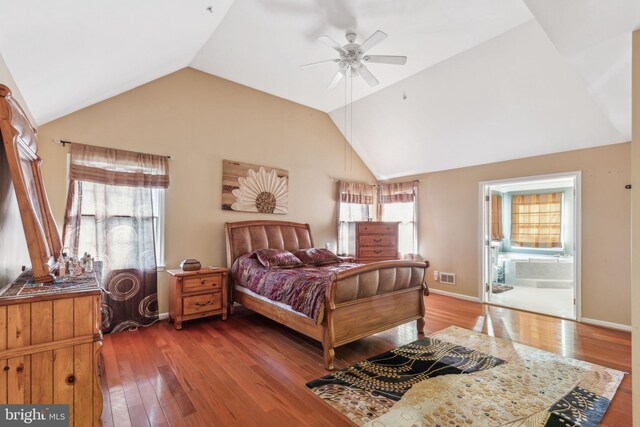 bedroom with connected bathroom, wood-type flooring, lofted ceiling, and ceiling fan