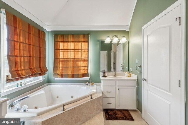 bathroom featuring vanity, a relaxing tiled tub, tile patterned flooring, and vaulted ceiling