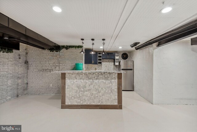 bar with brick wall, stainless steel fridge, and decorative light fixtures