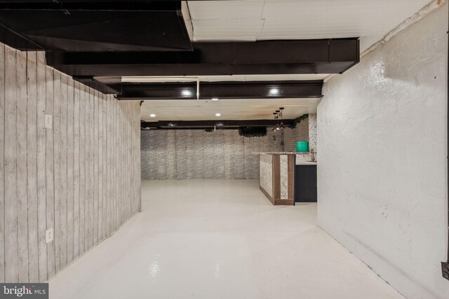 basement featuring wooden walls