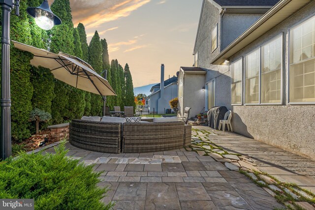 patio terrace at dusk featuring outdoor lounge area