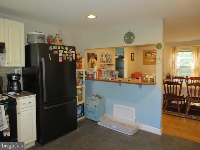 kitchen with dark wood-type flooring, ventilation hood, black appliances, and white cabinetry