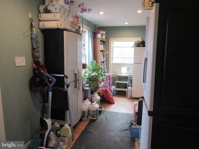 kitchen with light hardwood / wood-style floors and white fridge