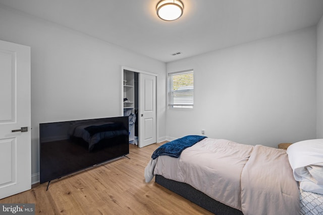 bedroom with light hardwood / wood-style flooring and a closet