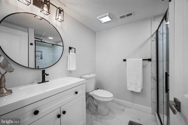 bathroom with vanity, a shower with shower door, and toilet