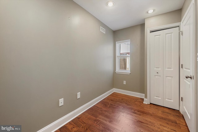 unfurnished bedroom featuring a closet and wood-type flooring