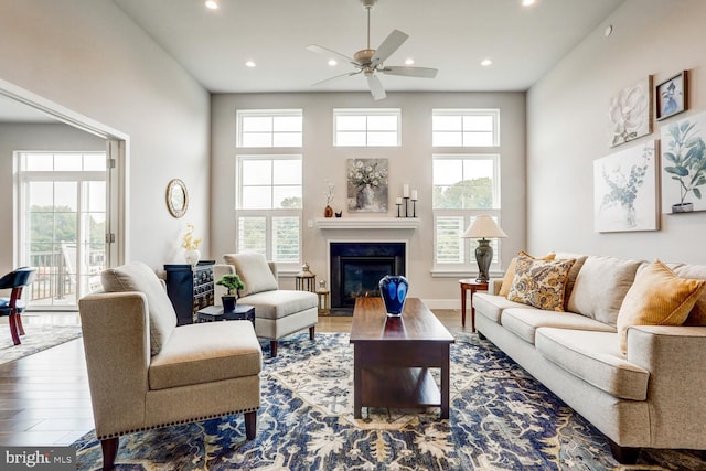 living room with a healthy amount of sunlight, ceiling fan, and hardwood / wood-style floors