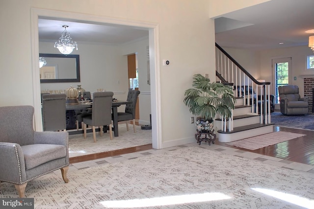 interior space featuring a notable chandelier, ornamental molding, and hardwood / wood-style floors