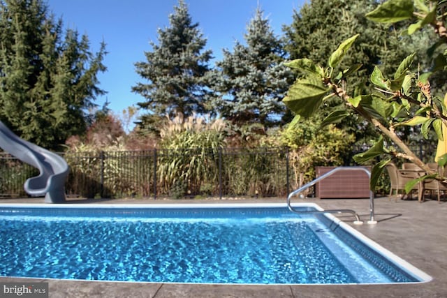 view of swimming pool featuring a patio area and a water slide