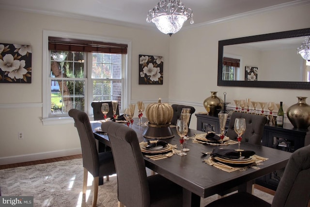 dining room with an inviting chandelier, crown molding, and wood-type flooring