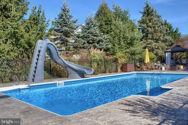 view of pool with a gazebo, a water slide, and a patio