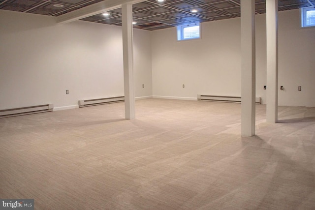 basement with a baseboard radiator and light carpet