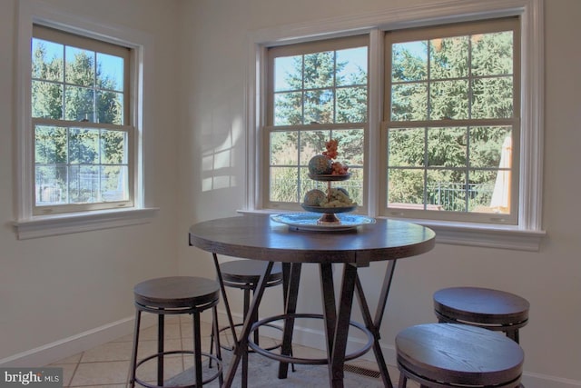 dining room with plenty of natural light and light tile patterned floors