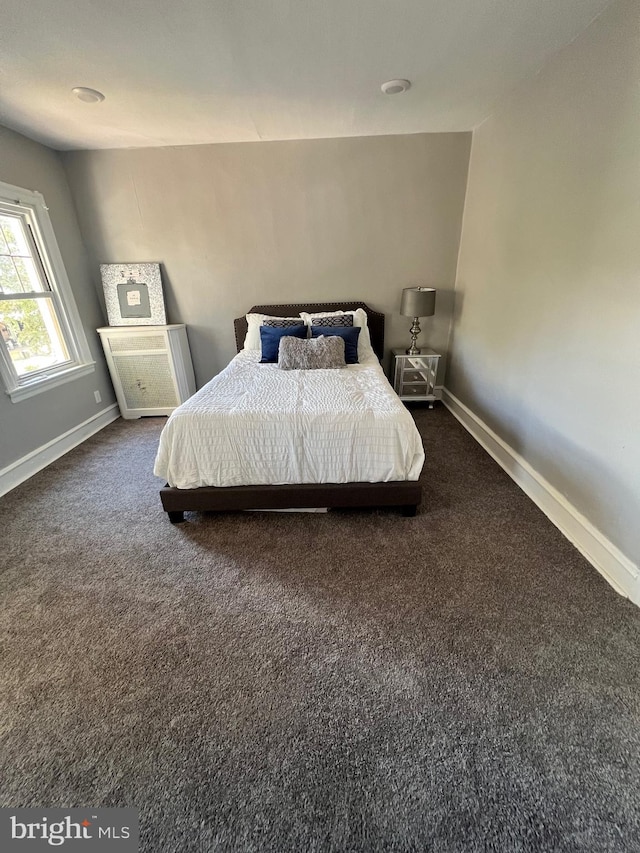 bedroom with dark carpet