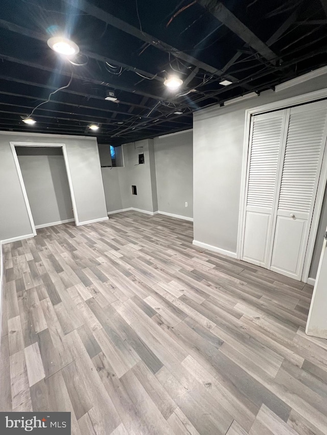 basement featuring light hardwood / wood-style flooring