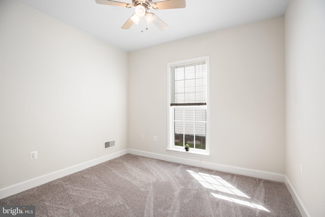 spare room featuring carpet and ceiling fan