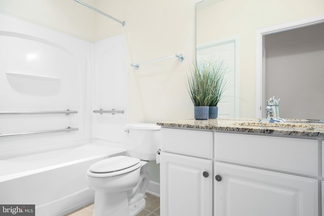 bathroom featuring vanity, tile patterned floors, and toilet