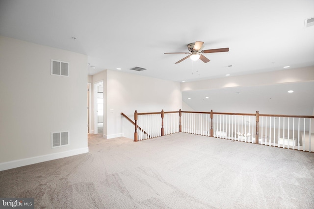 spare room featuring ceiling fan and light carpet